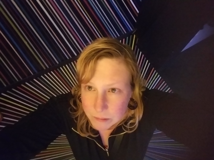 Picture of Deb looking up with dark background